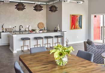 A dining room table with a vase of flowers on it
